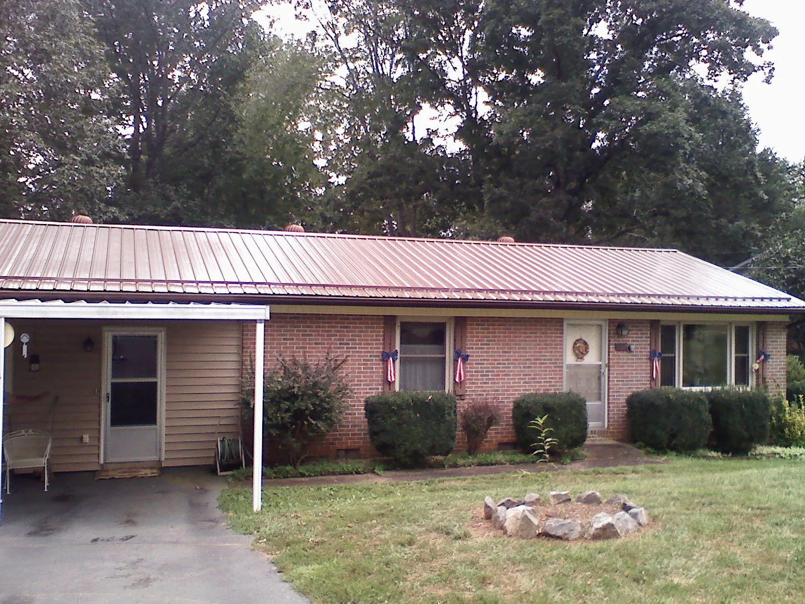 Bronze metal roof and carport on a brick ranch home — Roof Repair work by our crew in Upperville