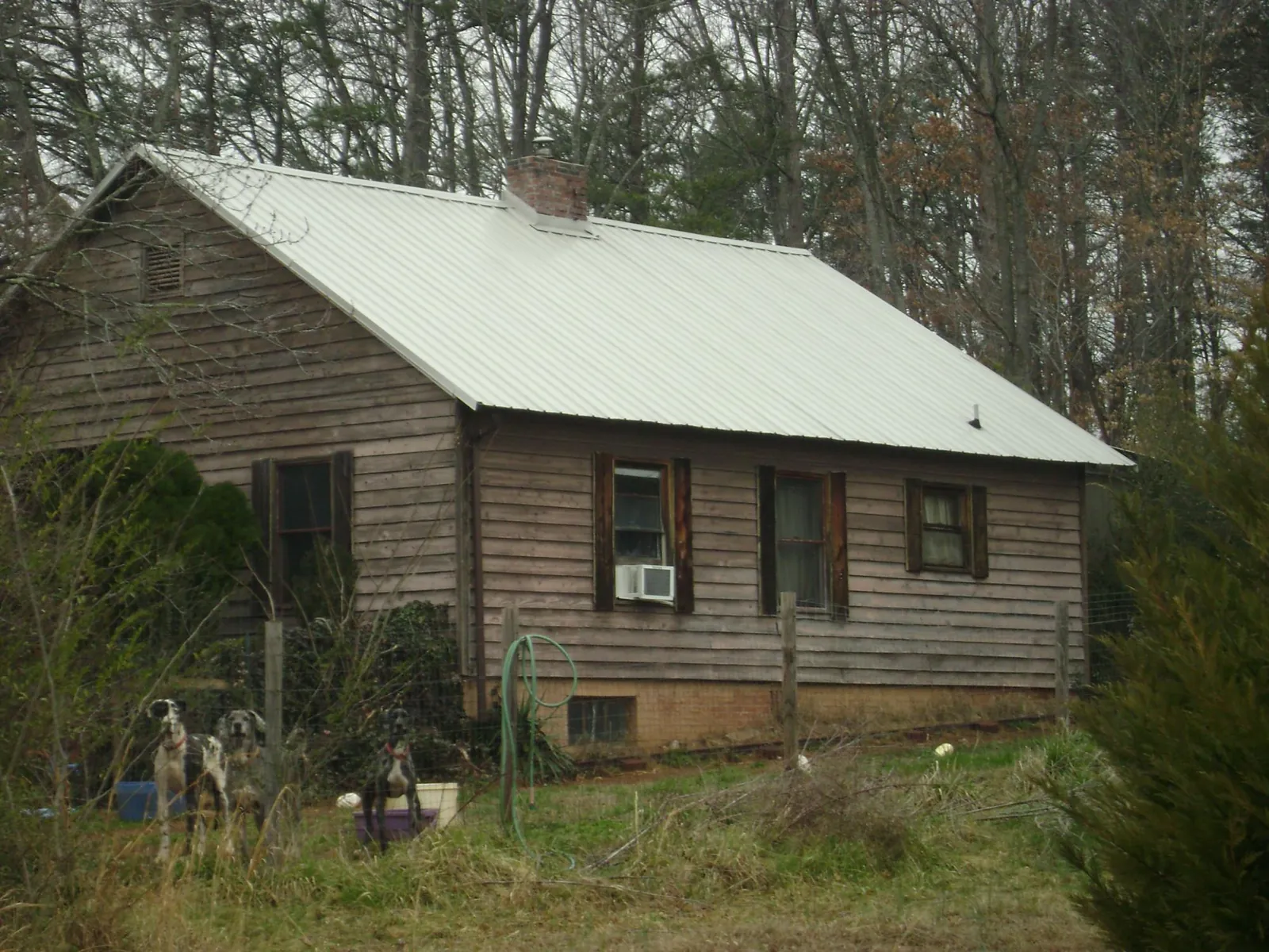 White metal roof on an old wood sided farmhouse, from a Metal Roof Installation job in Upperville